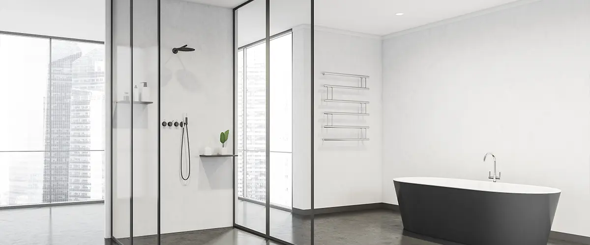 Bathroom space with half-glass cabin in center and black bathtub