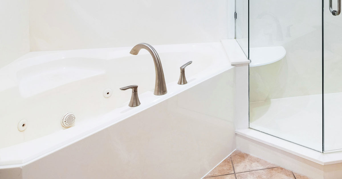 Spacious bathroom featuring an acrylic bathtub and glass shower enclosure