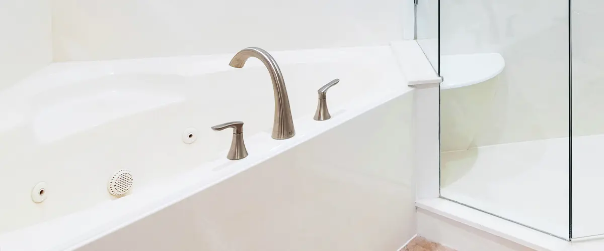 Spacious bathroom featuring an acrylic bathtub and glass shower enclosure